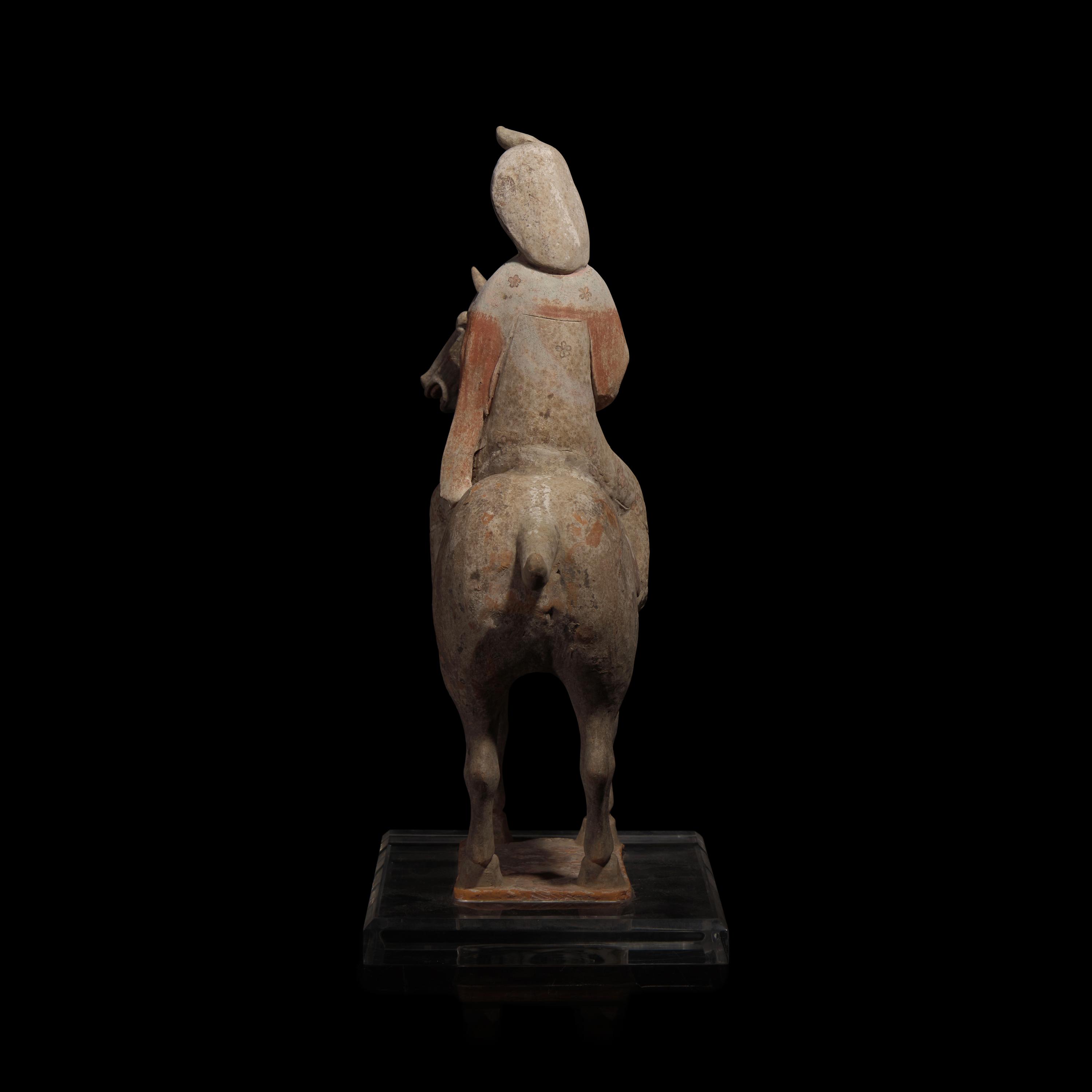A Chinese Painted Pottery Female Equestrian Figure, Tang Dynasty — 唐 陶加彩女騎馬俑