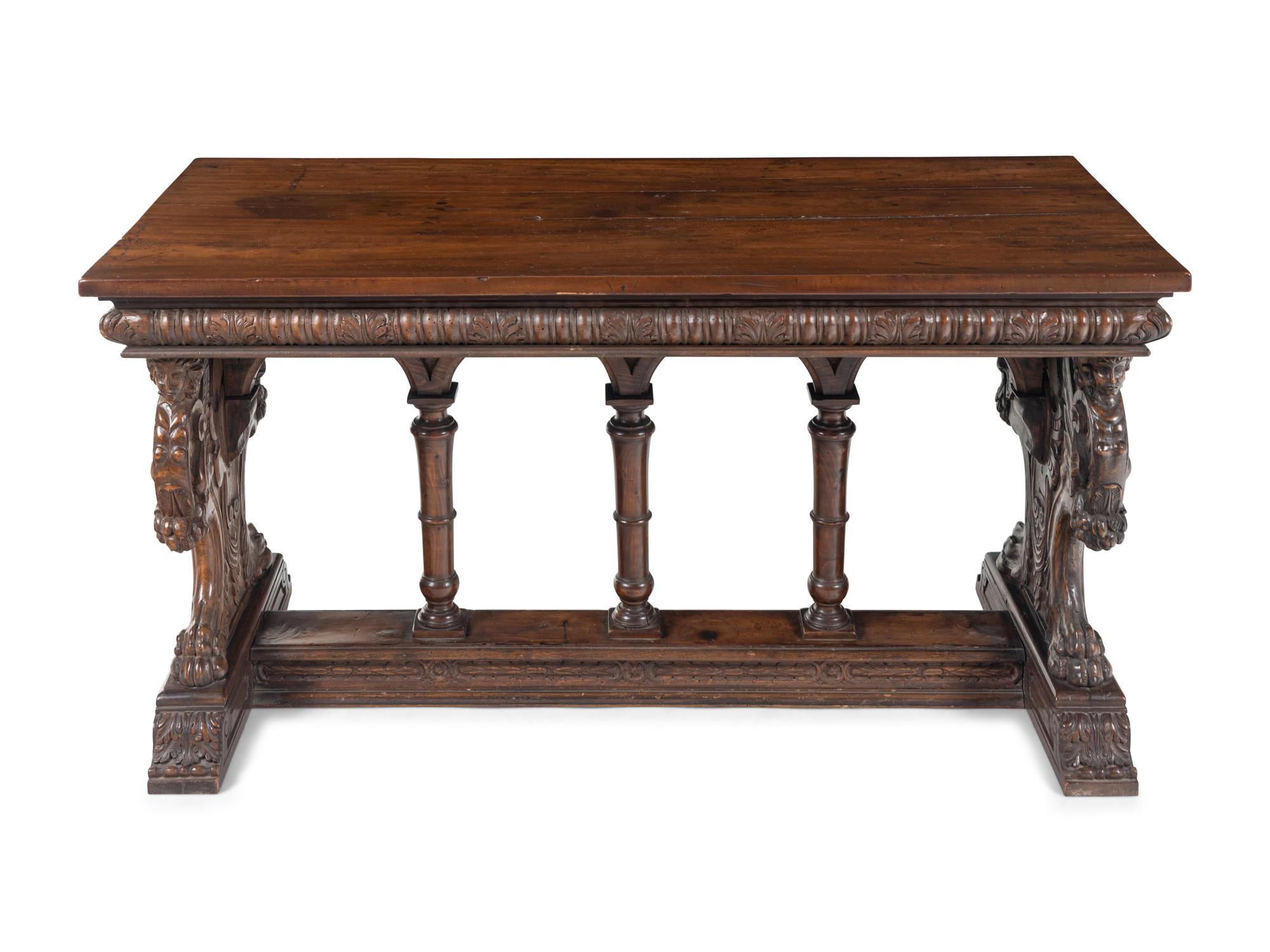 A Florentine Renaissance Style Carved Walnut Trestle Table