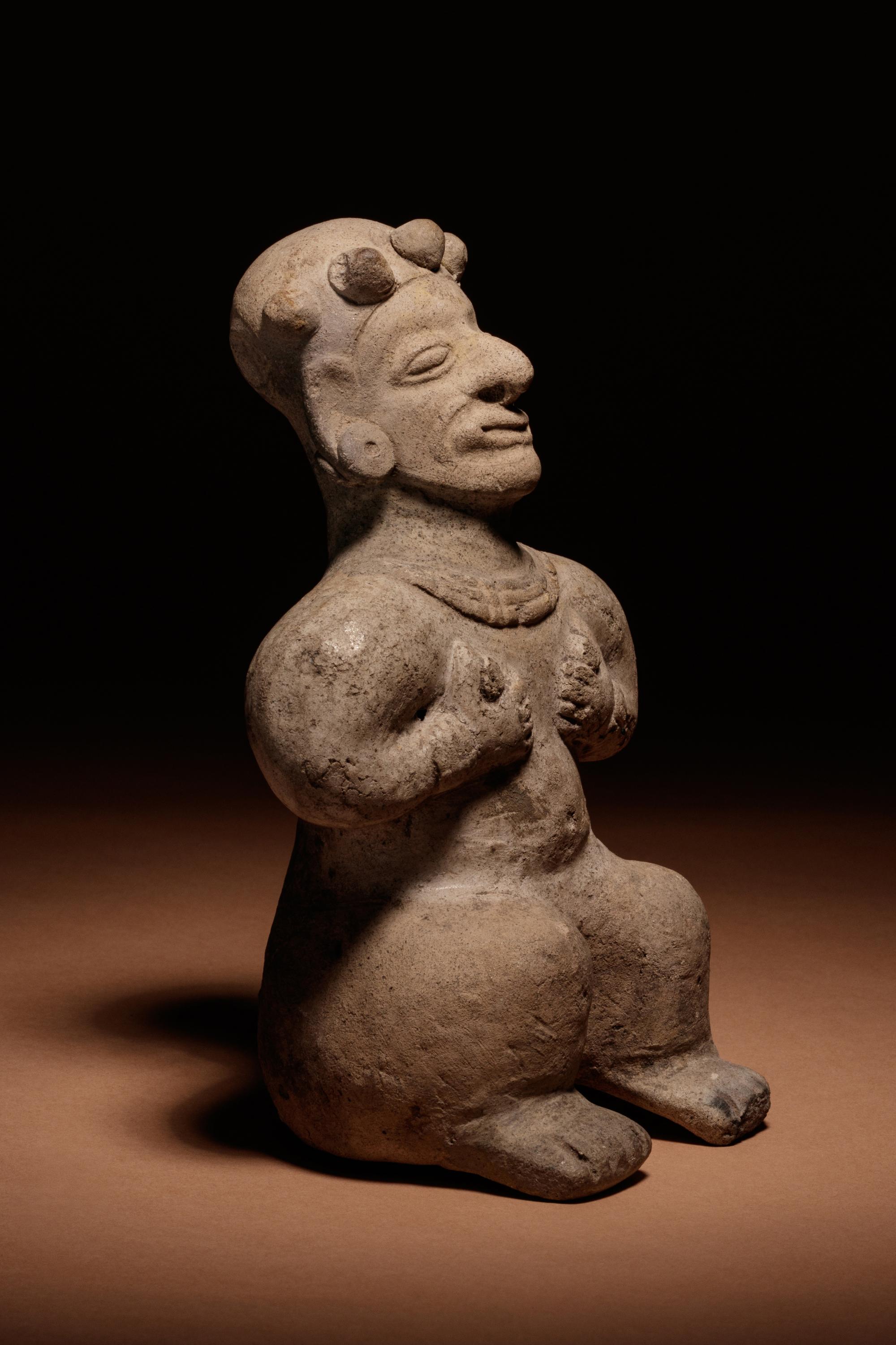 A Tumaco Female Figure Holding Breasts