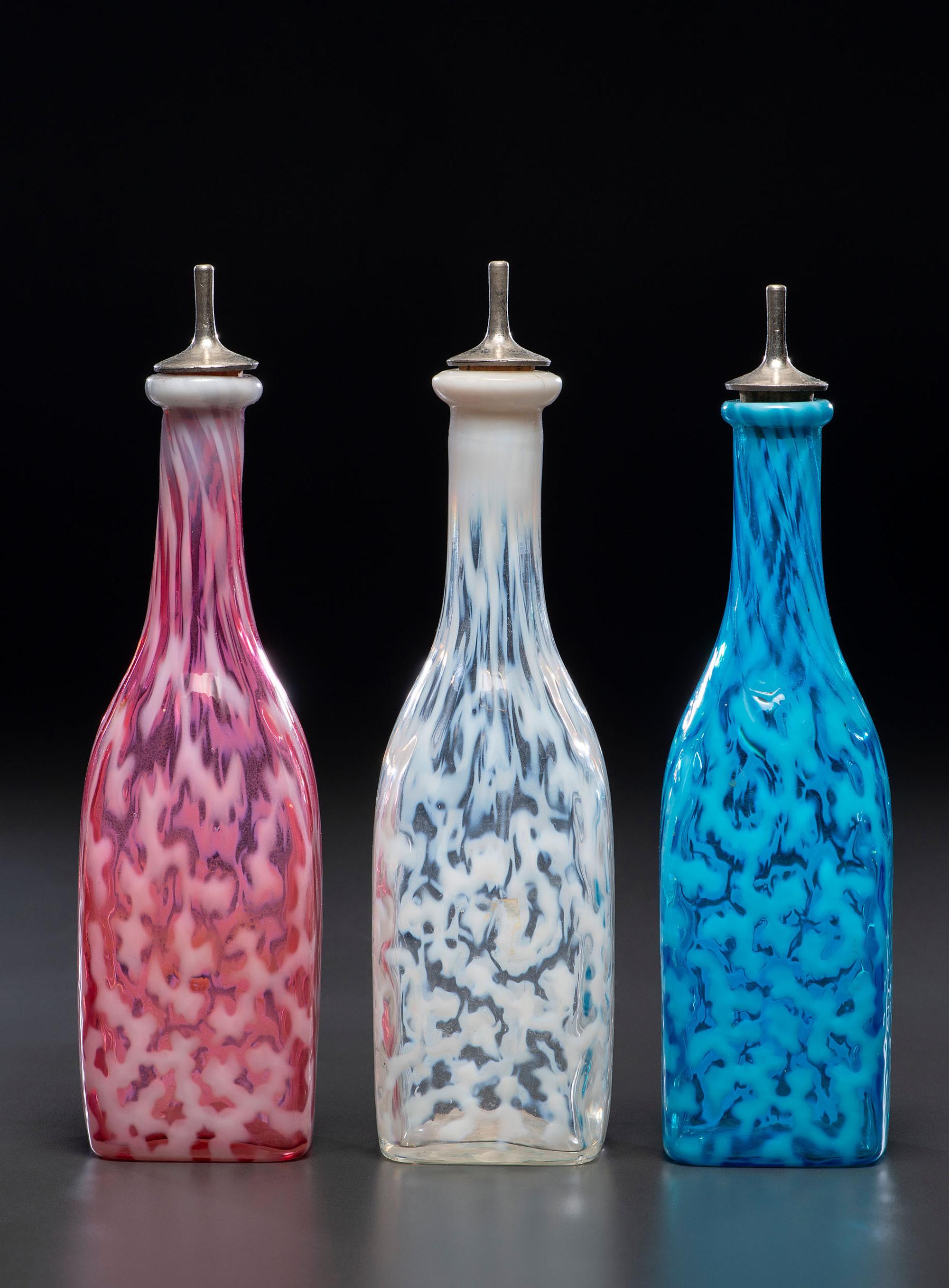 Three Coral Opalescent Glass Barber's Bottles