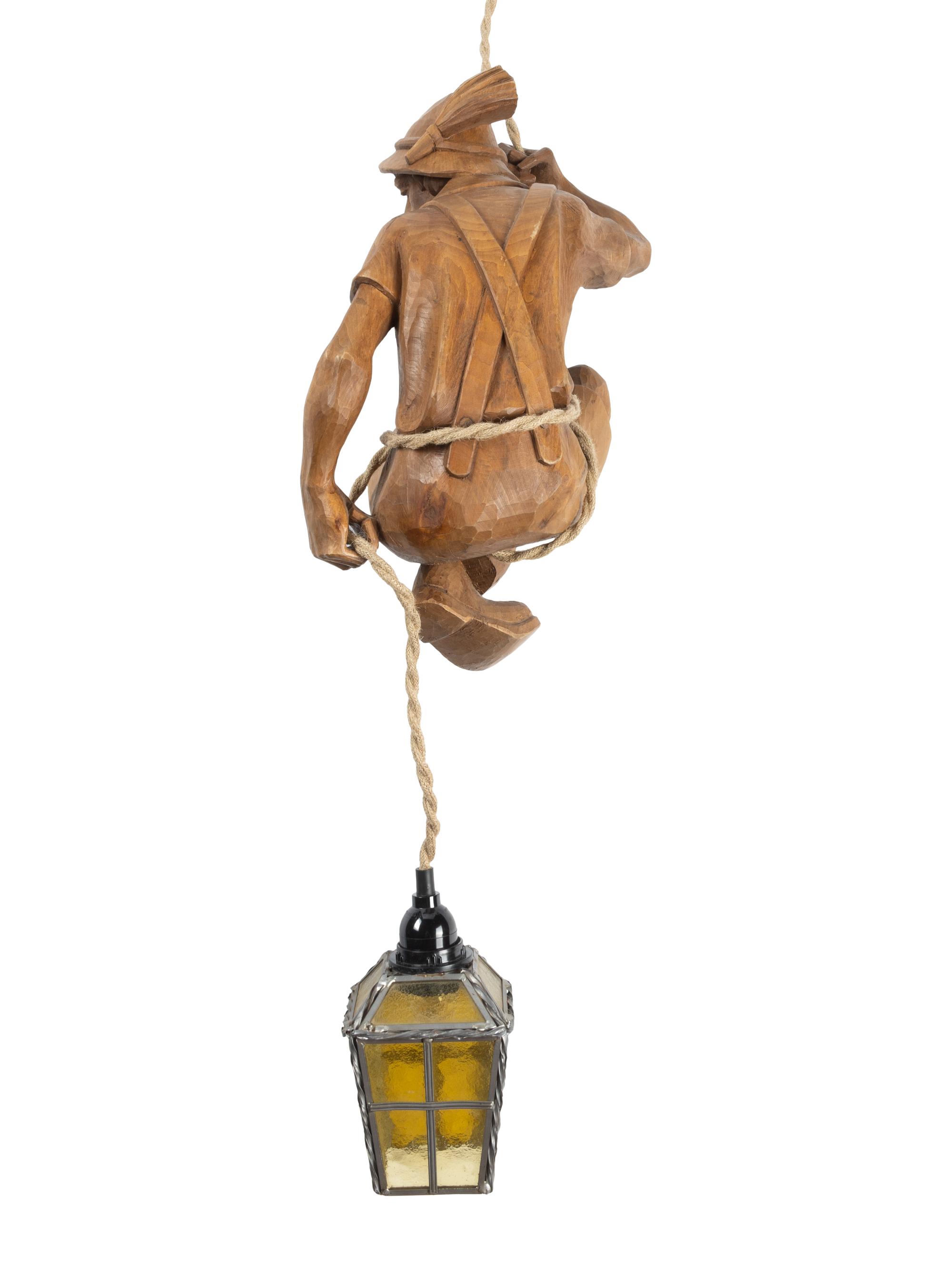 A Swiss Carved Wood "Mountain Climber" Lamp