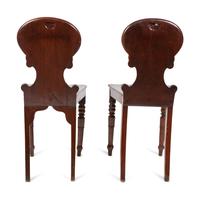 A Pair of Regency Style Mahogany Hall Chairs