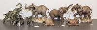 A Group of Eight Porcelain Elephant Figures Height of tallest 8 inches.
