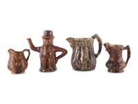 A Group of Molded Teapots and Jugs in Rockingham Glaze