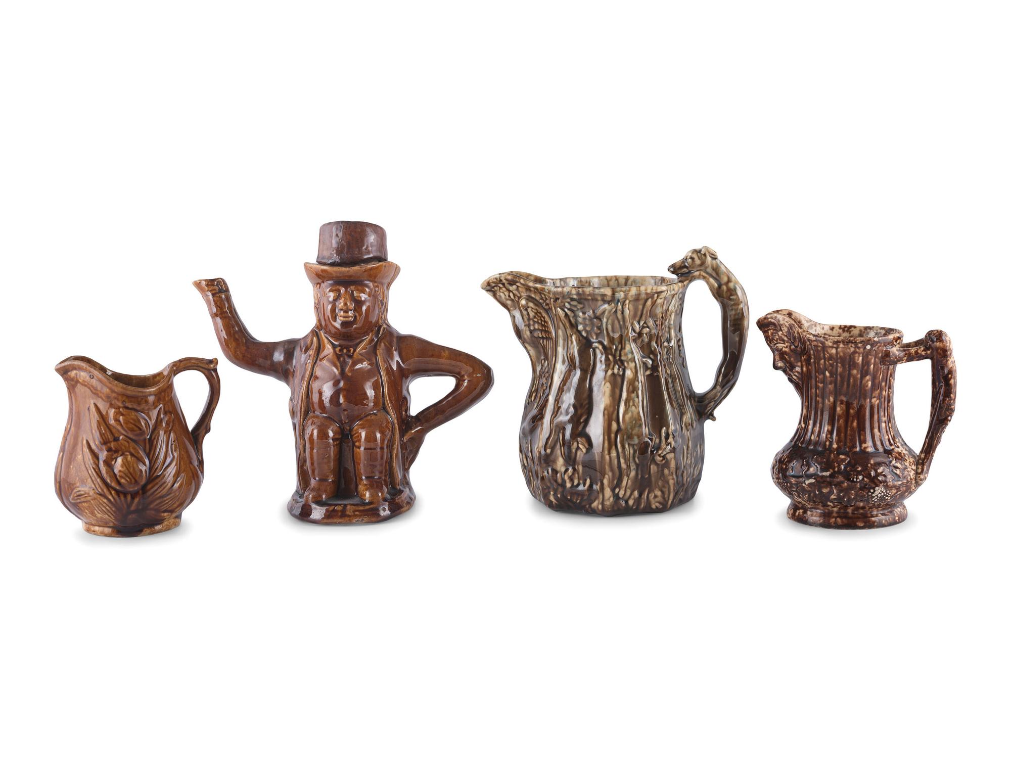 A Group of Molded Teapots and Jugs in Rockingham Glaze