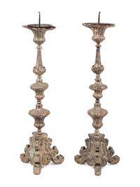 A Pair of Baroque Repoussé Decorated Silvered Metal Pricket Sticks