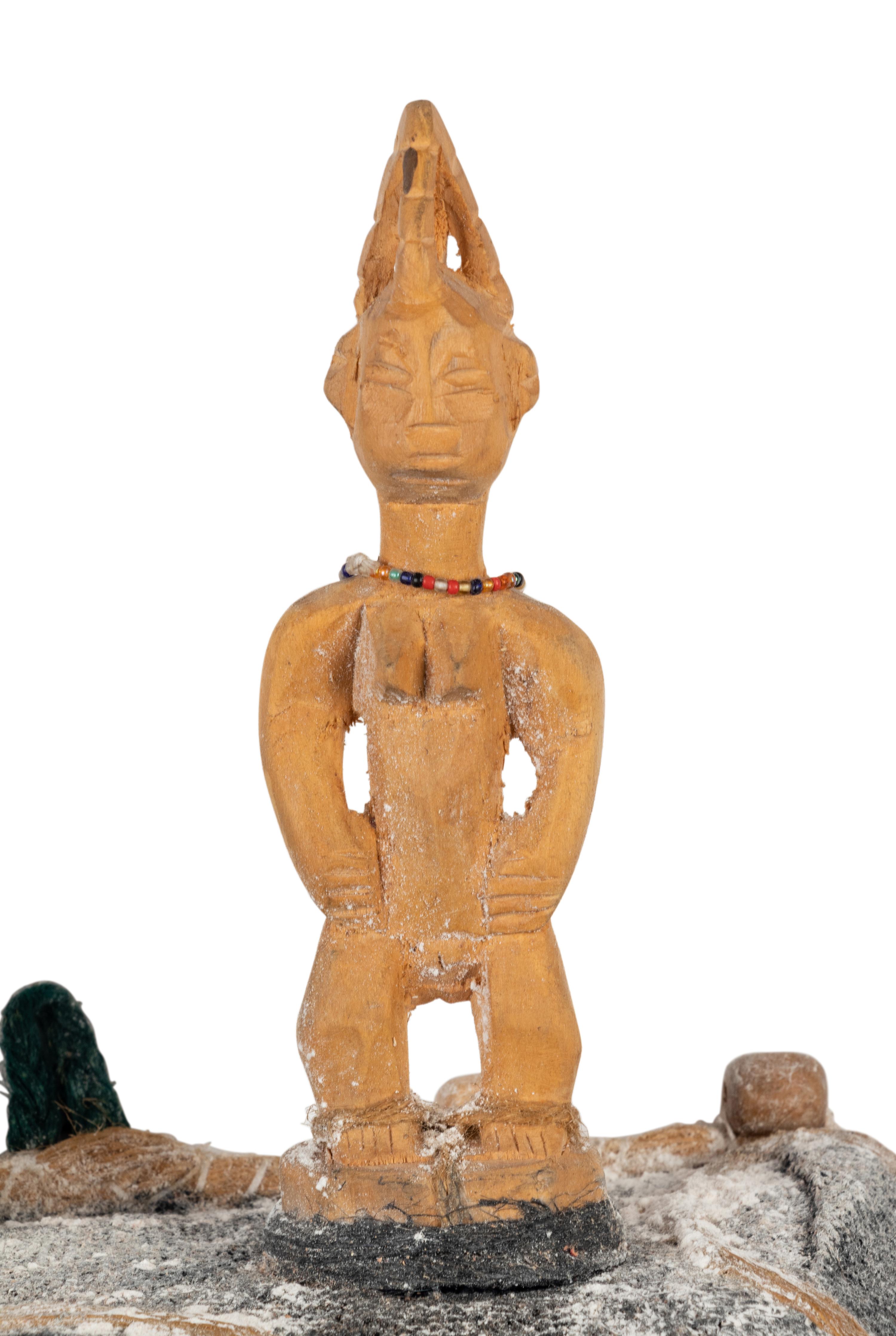 A Benin Shell and Woven Reed Mask with Carved Figures