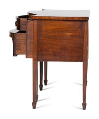 A Regency Style "Plum-Pudding" Mahogany Serpentine Sideboard
