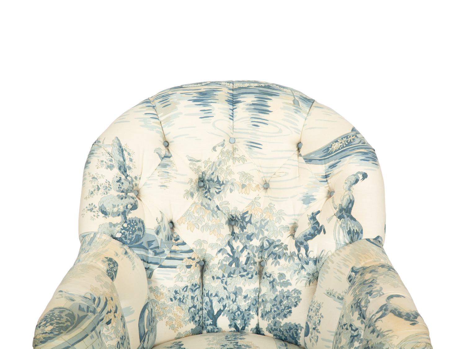 A Blue, White and Cream Upholstered Club Chair and Ottoman