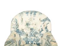 A Blue, White and Cream Upholstered Club Chair and Ottoman