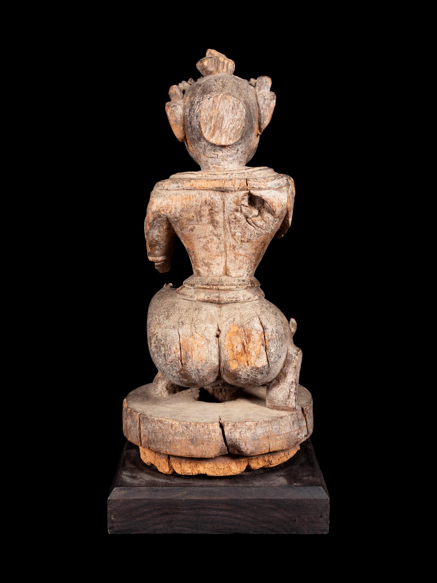 An Indian Carved Wood Figure of a Deity