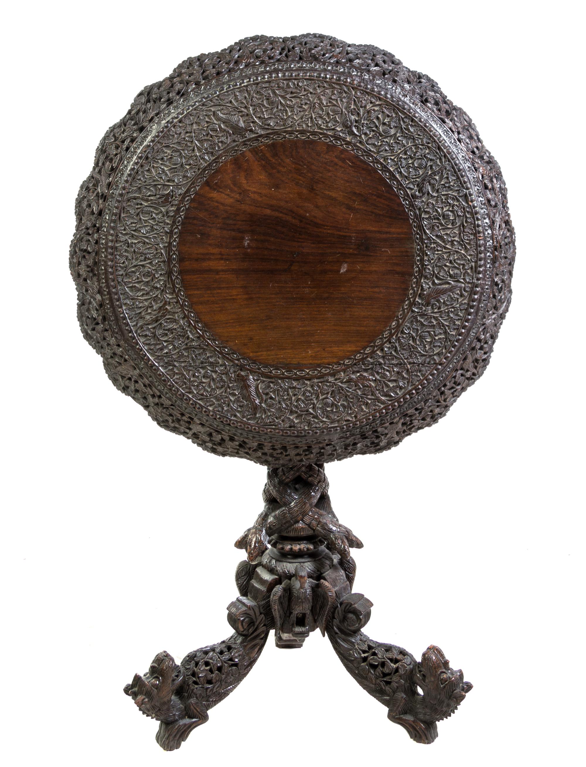 An Anglo-Indian Carved Hardwood Tilt-Top Table Height 30 3/4 x diameter 28 1/4 inches. — LATE 19TH/EARLY 20TH CENTURY