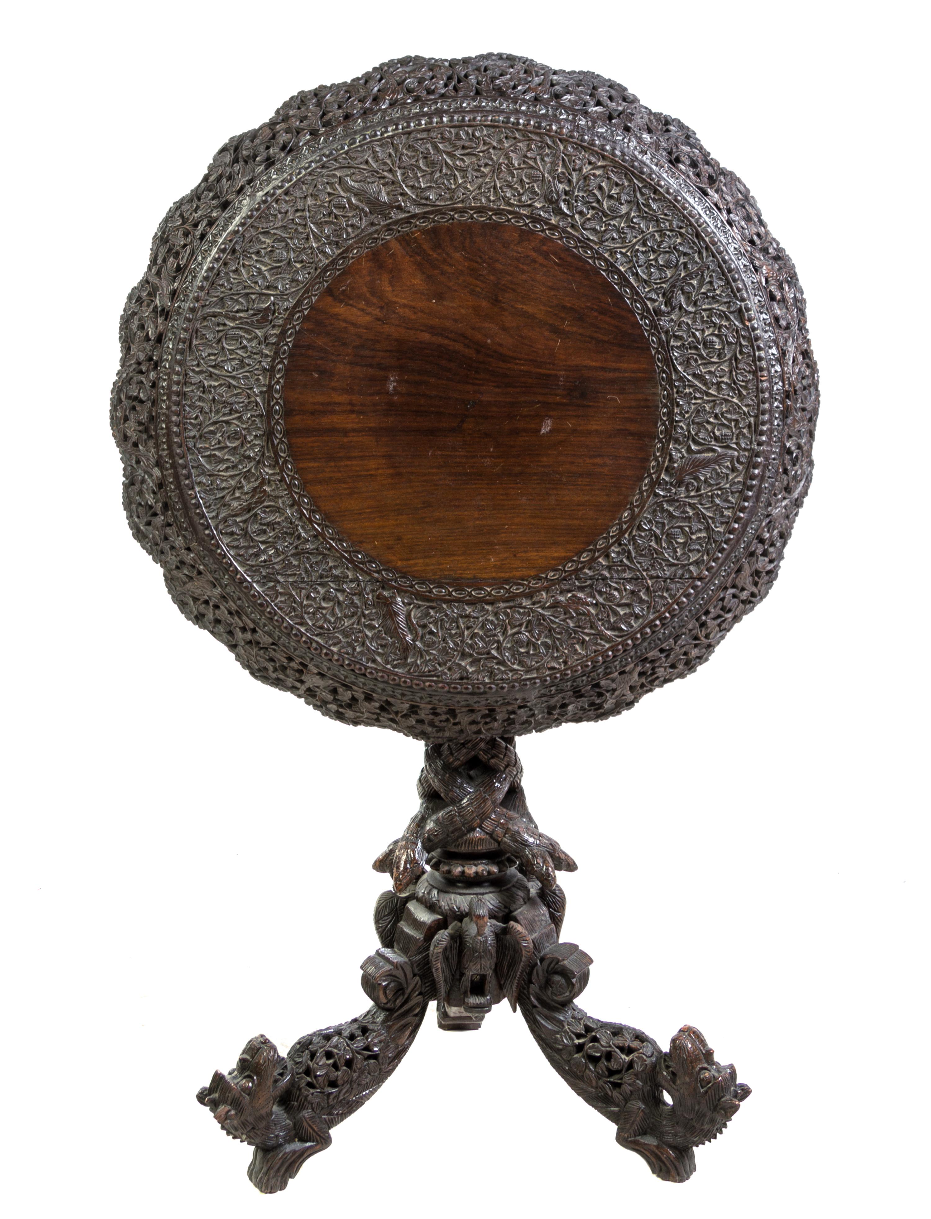 An Anglo-Indian Carved Hardwood Tilt-Top Table Height 30 3/4 x diameter 28 1/4 inches. — LATE 19TH/EARLY 20TH CENTURY
