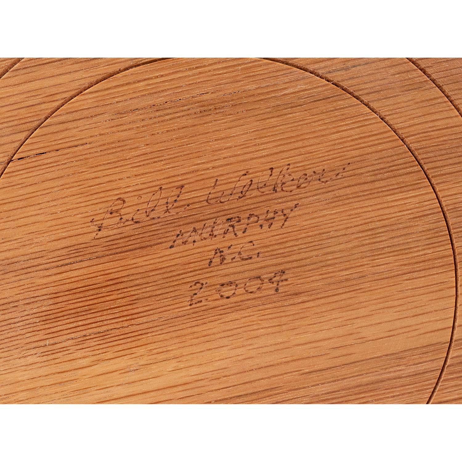 A Turned and Segmented Wood Vase in the style of Ray Allen