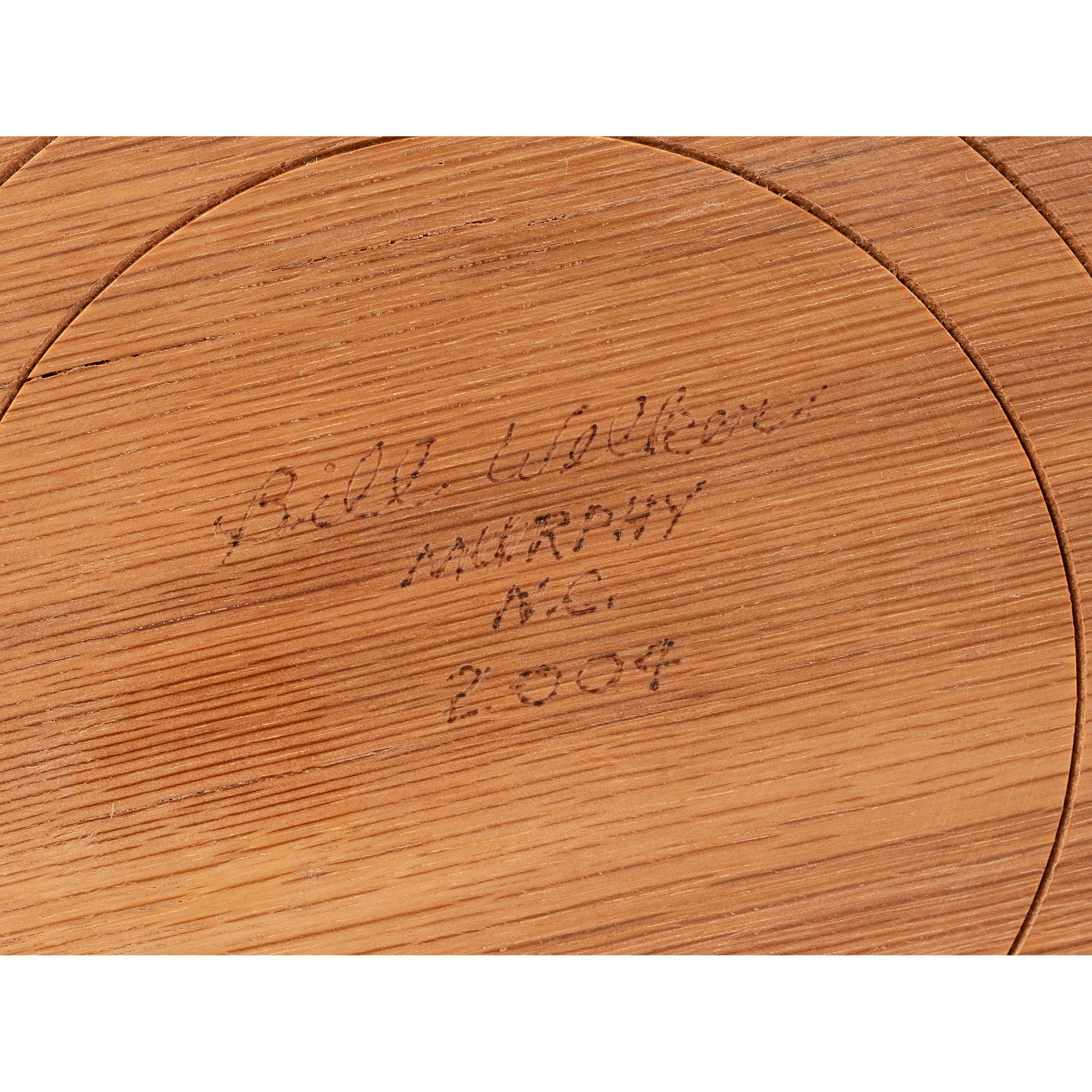 A Turned and Segmented Wood Vase in the style of Ray Allen
