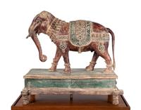 An Indian Carved Wood Model of an Elephant in a Walnut and Glass Vitrine