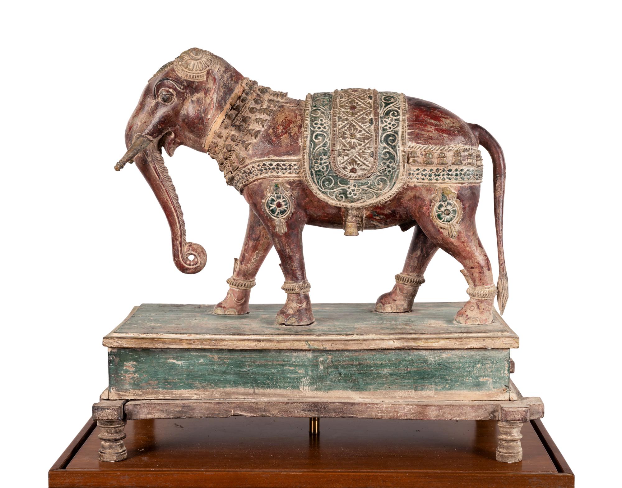 An Indian Carved Wood Model of an Elephant in a Walnut and Glass Vitrine