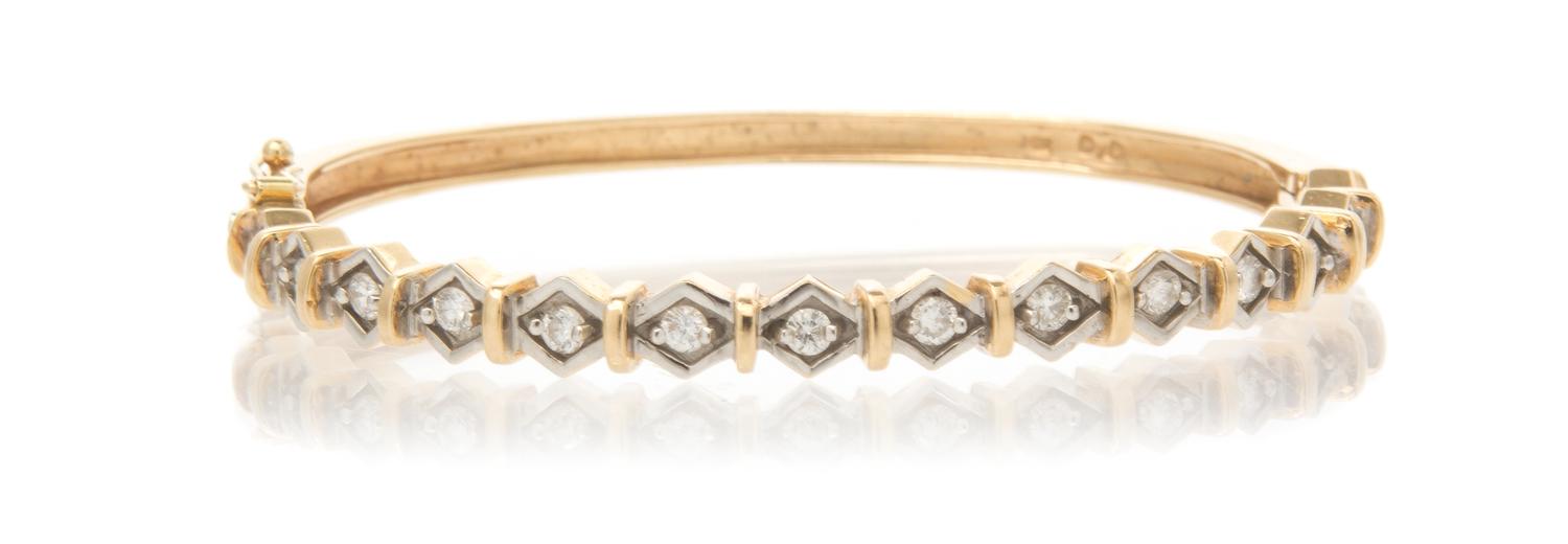 A 14 Karat Yellow Gold and Diamond Hinged Bangle Bracelet, 10.40 dwts.