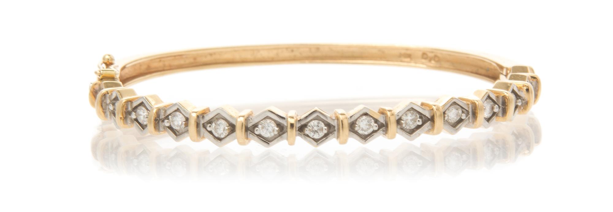 A 14 Karat Yellow Gold and Diamond Hinged Bangle Bracelet, 10.40 dwts.