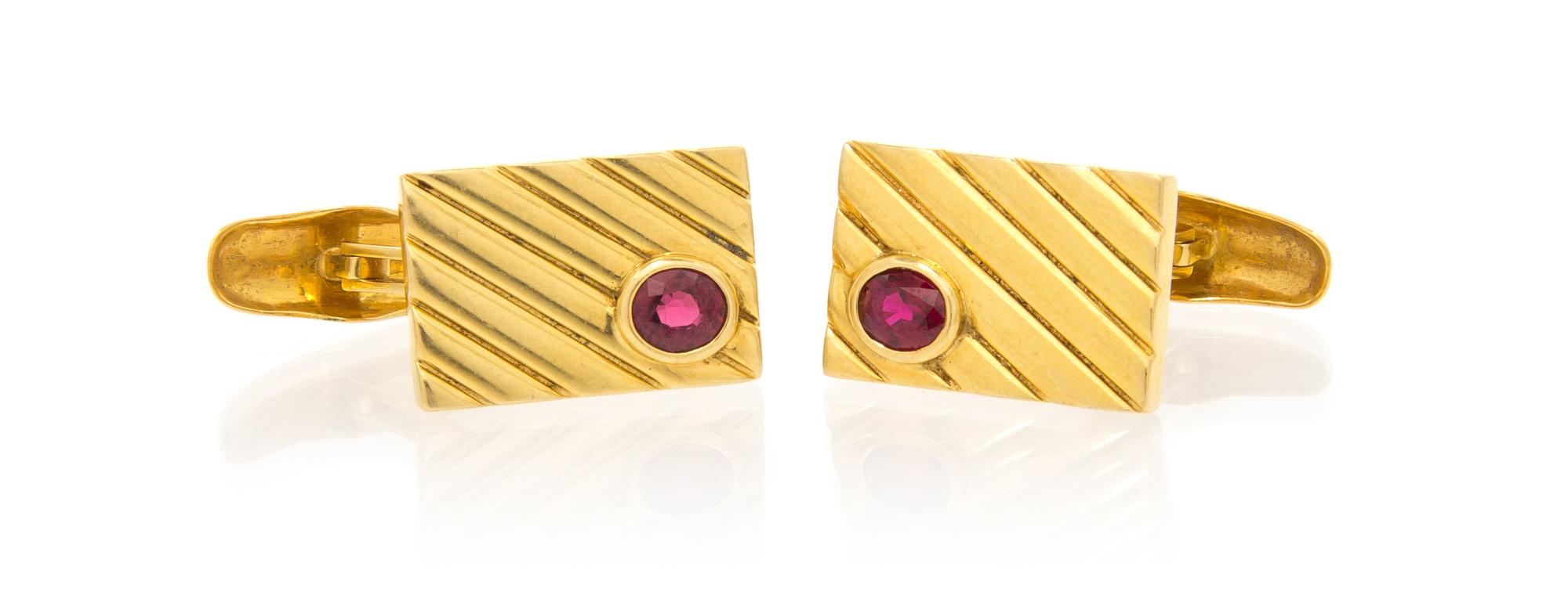 A Pair of 18 Karat Yellow Gold and Ruby Cufflinks, 9.10 dwts.