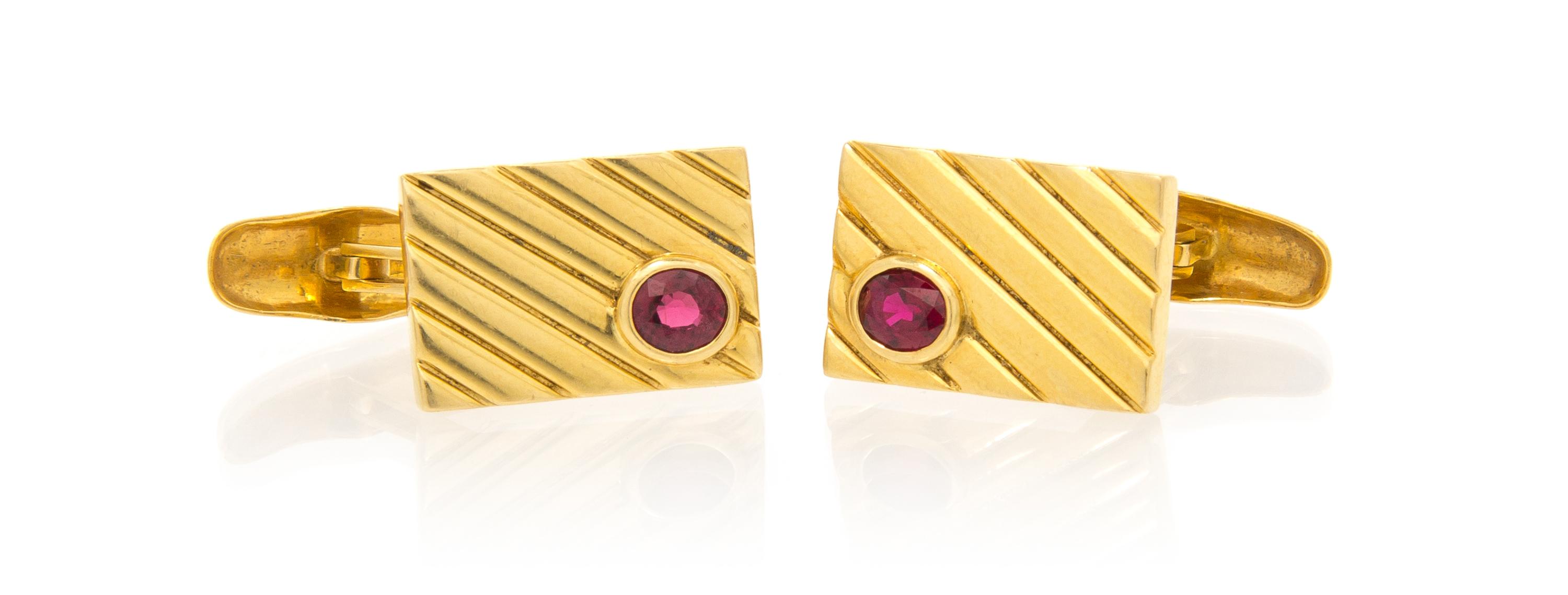A Pair of 18 Karat Yellow Gold and Ruby Cufflinks, 9.10 dwts.