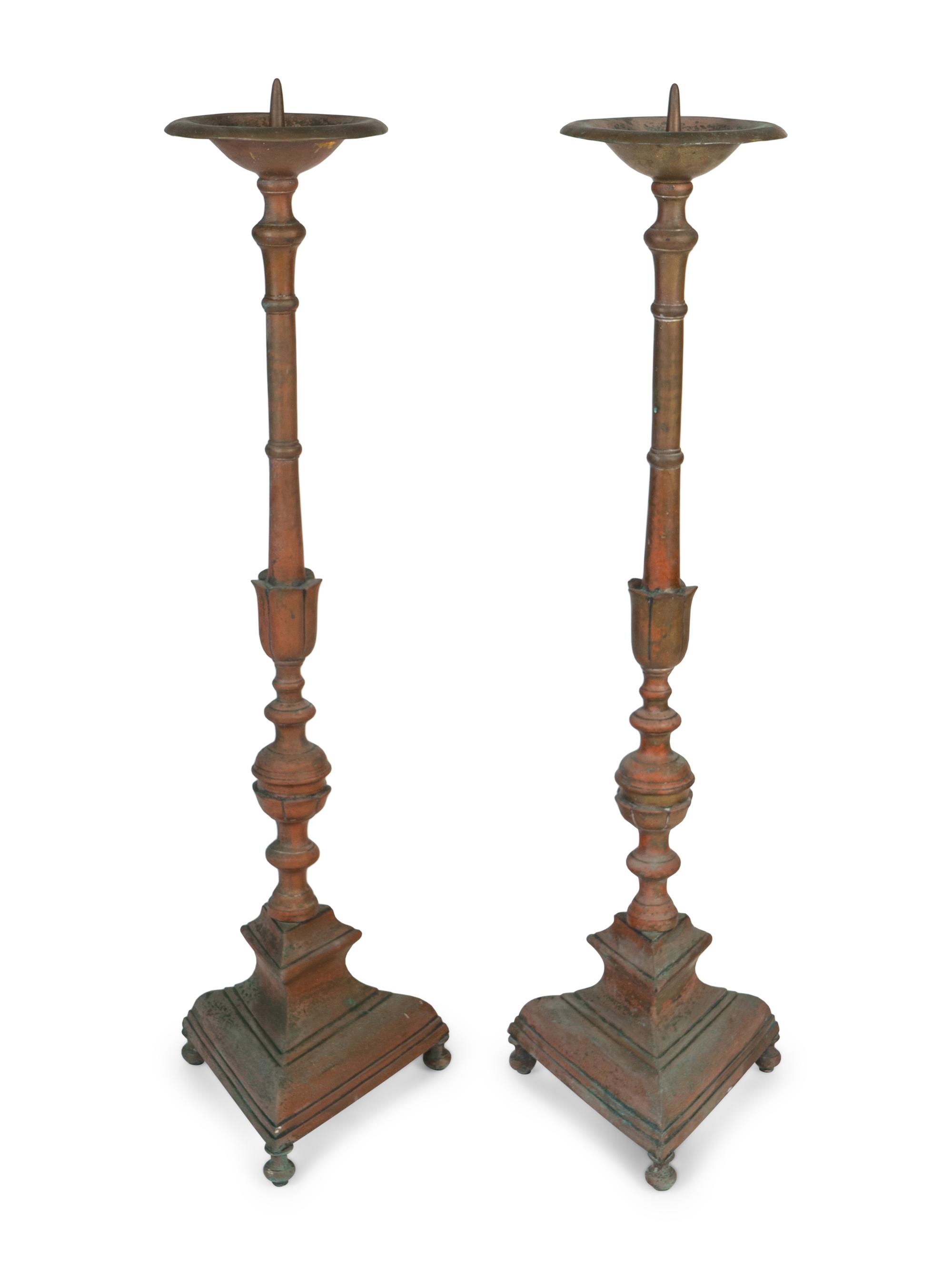A Large Pair of Italian Baroque Style Brass Pricketsticks