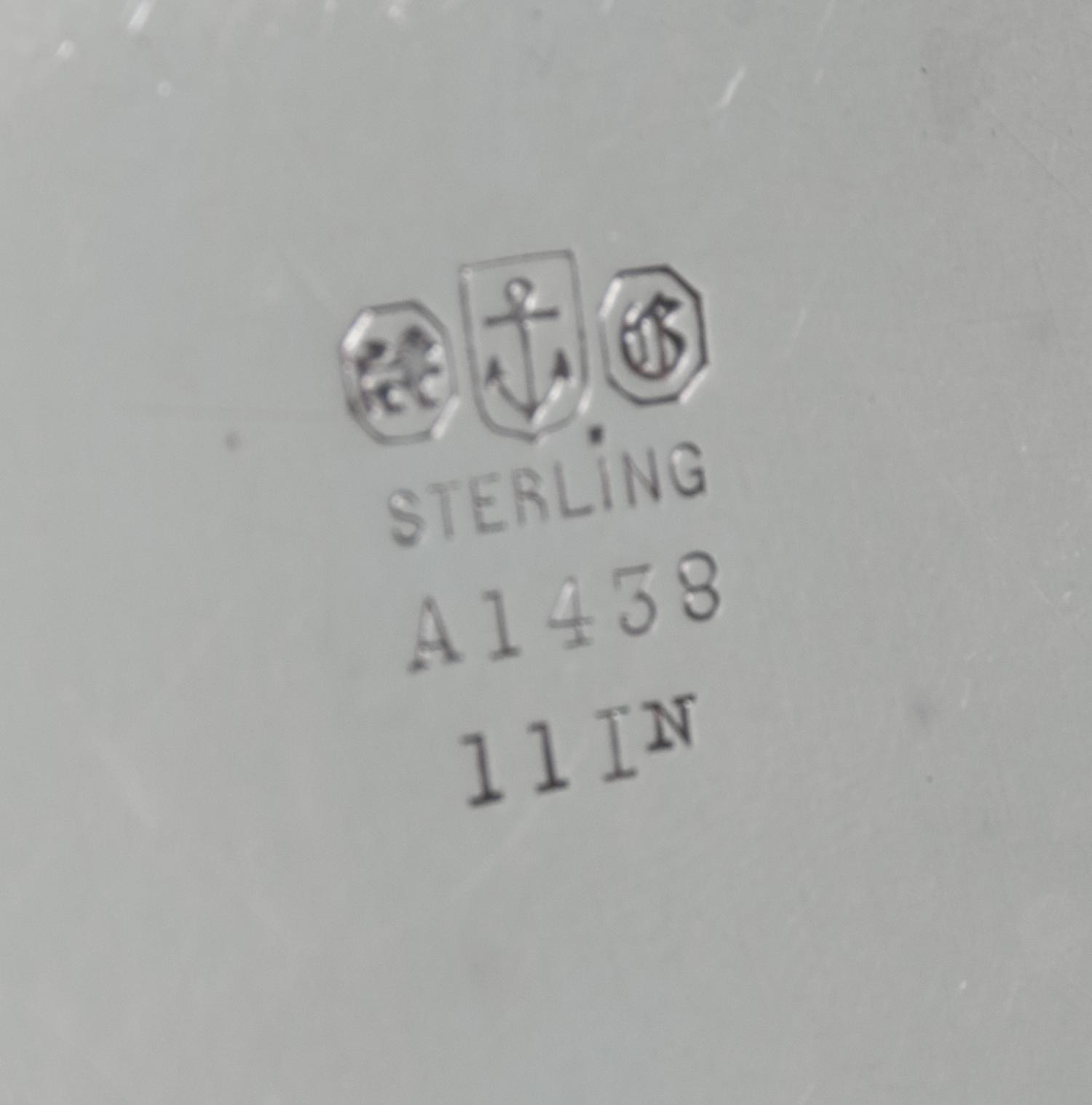 An American Silver Tray, Gorham Mfg. Co., Providence, RI, of circular form with an applied foliate scroll border surrounding a script m
