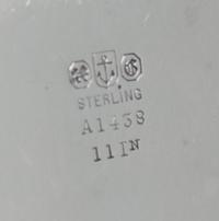 An American Silver Tray, Gorham Mfg. Co., Providence, RI, of circular form with an applied foliate scroll border surrounding a script m