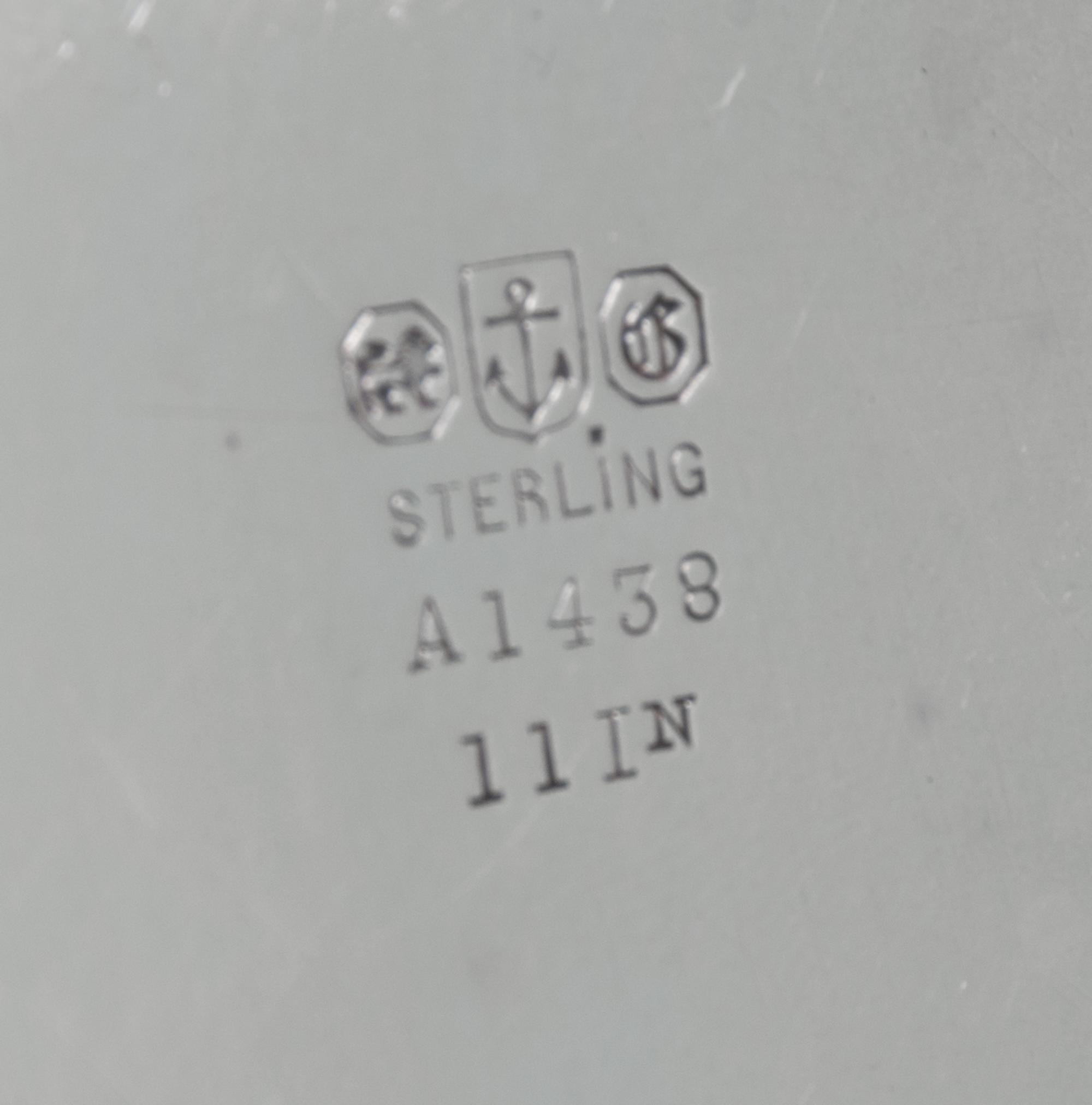 An American Silver Tray, Gorham Mfg. Co., Providence, RI, of circular form with an applied foliate scroll border surrounding a script m