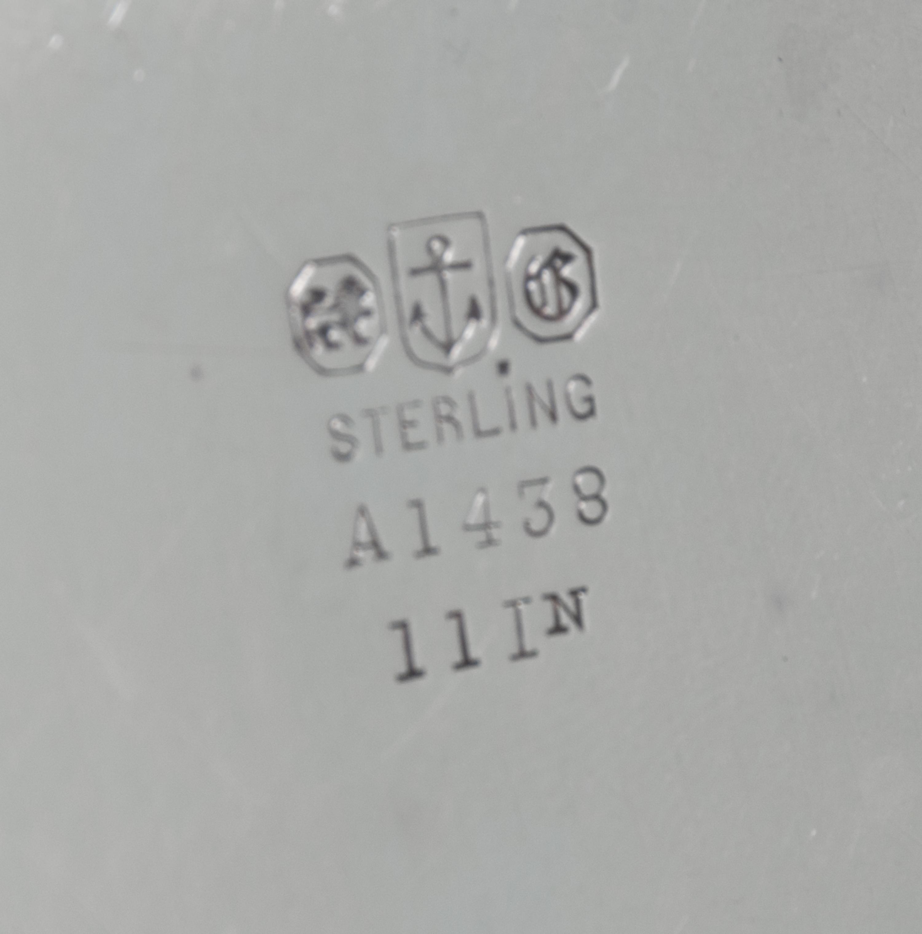 An American Silver Tray, Gorham Mfg. Co., Providence, RI, of circular form with an applied foliate scroll border surrounding a script m