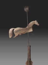 A Primitive Carved Pine and Cast Iron Horse Weathervane on Stand