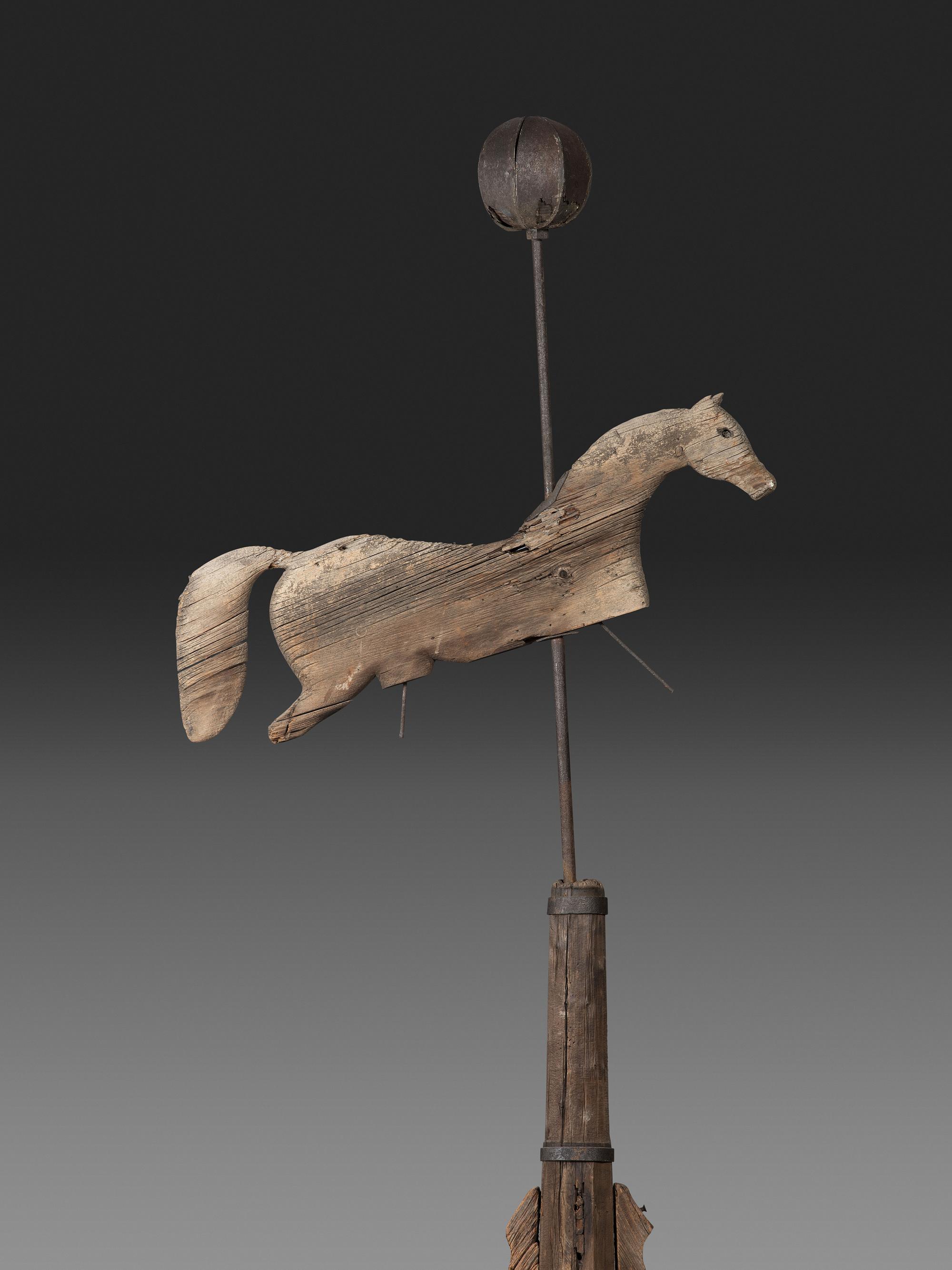A Primitive Carved Pine and Cast Iron Horse Weathervane on Stand