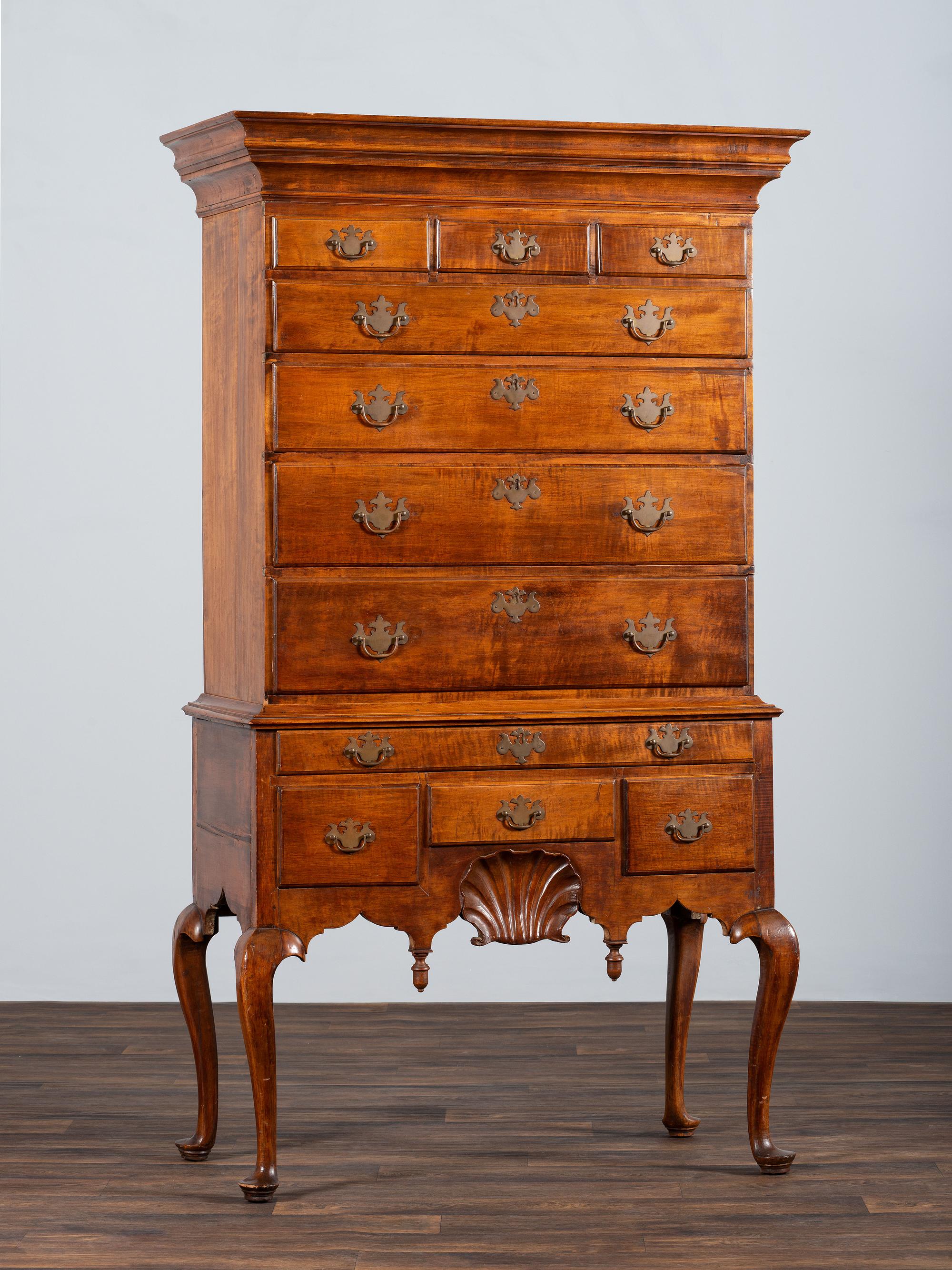 A Queen Anne Shell-Carved and Figured Maple Flat-Top High Chest of Drawers