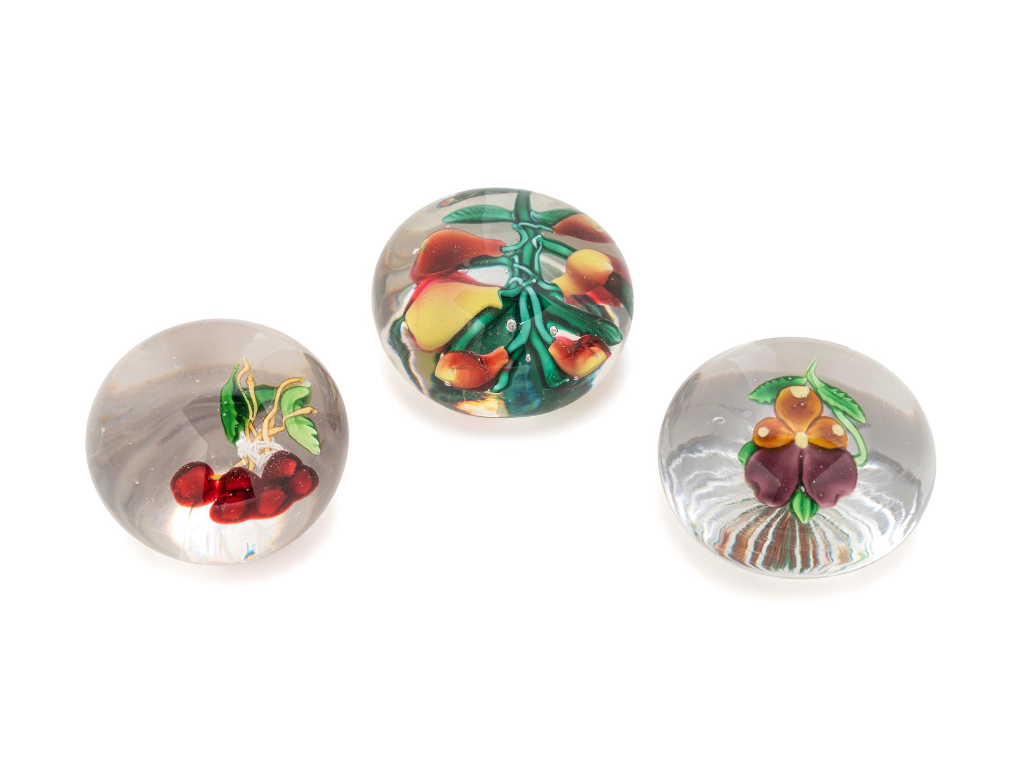 A Five Pears Glass Paperweight, a Bundle of Cherries Glass Paperweight and a Pansy Glass Paperweight