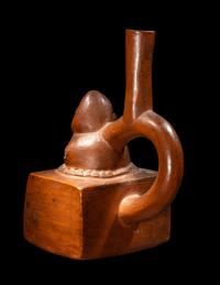 A Chimu-Inca Redware Stirrup Vessel with Squared Body and Human Figure