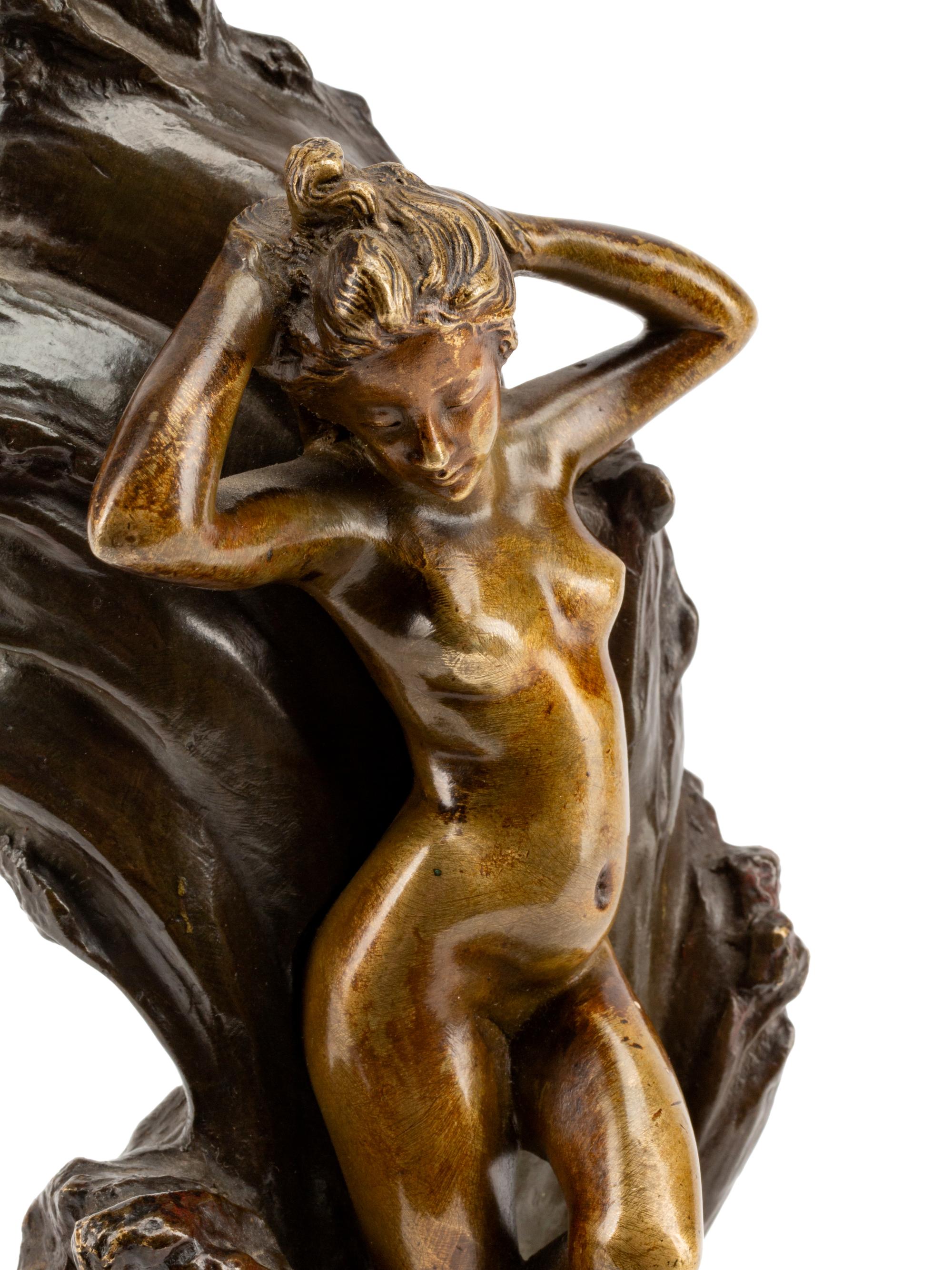 A Continental Gilt and Patinated Bronze Figure of a Nude Against Waves