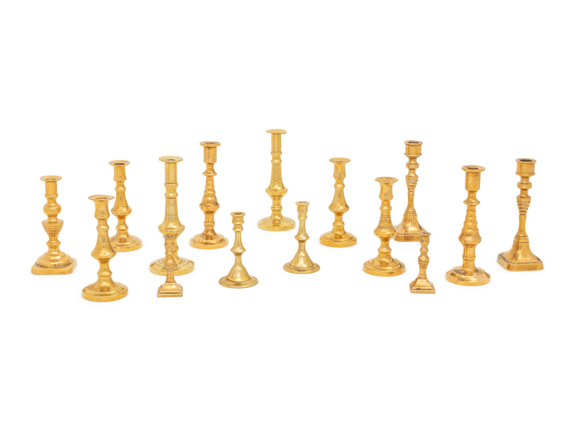 A Collection of Fifteen English Brass Diminutive Candlesticks and Tapersticks