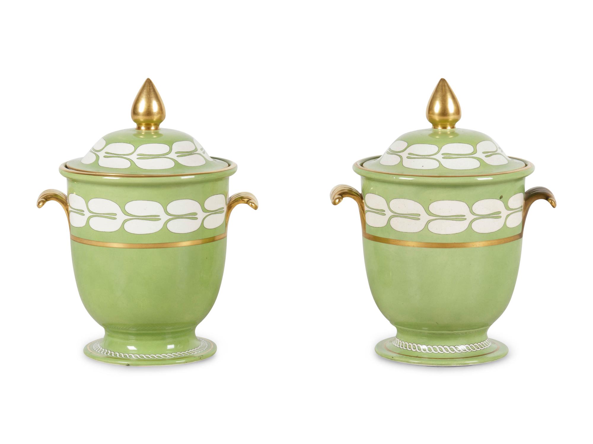 A Pair of Porcelain Covered Urns
