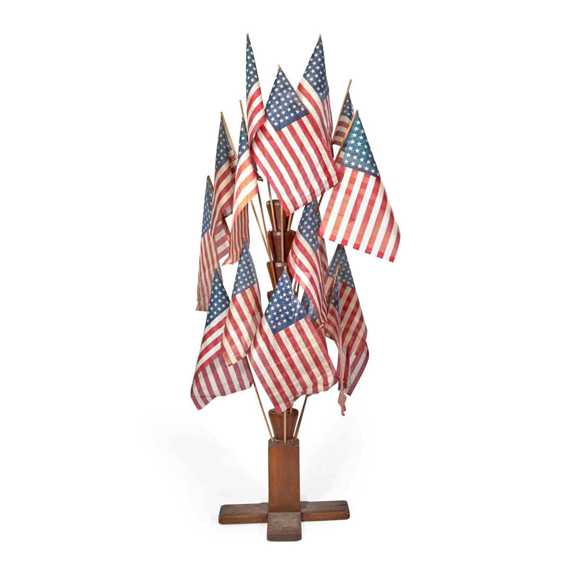 [FLAGS]. A large 9-tier wooden flag stand. Late 19th century.