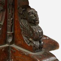 A Gothic Revival carved oak dining table composed of elements likely dating to the 17th century and later