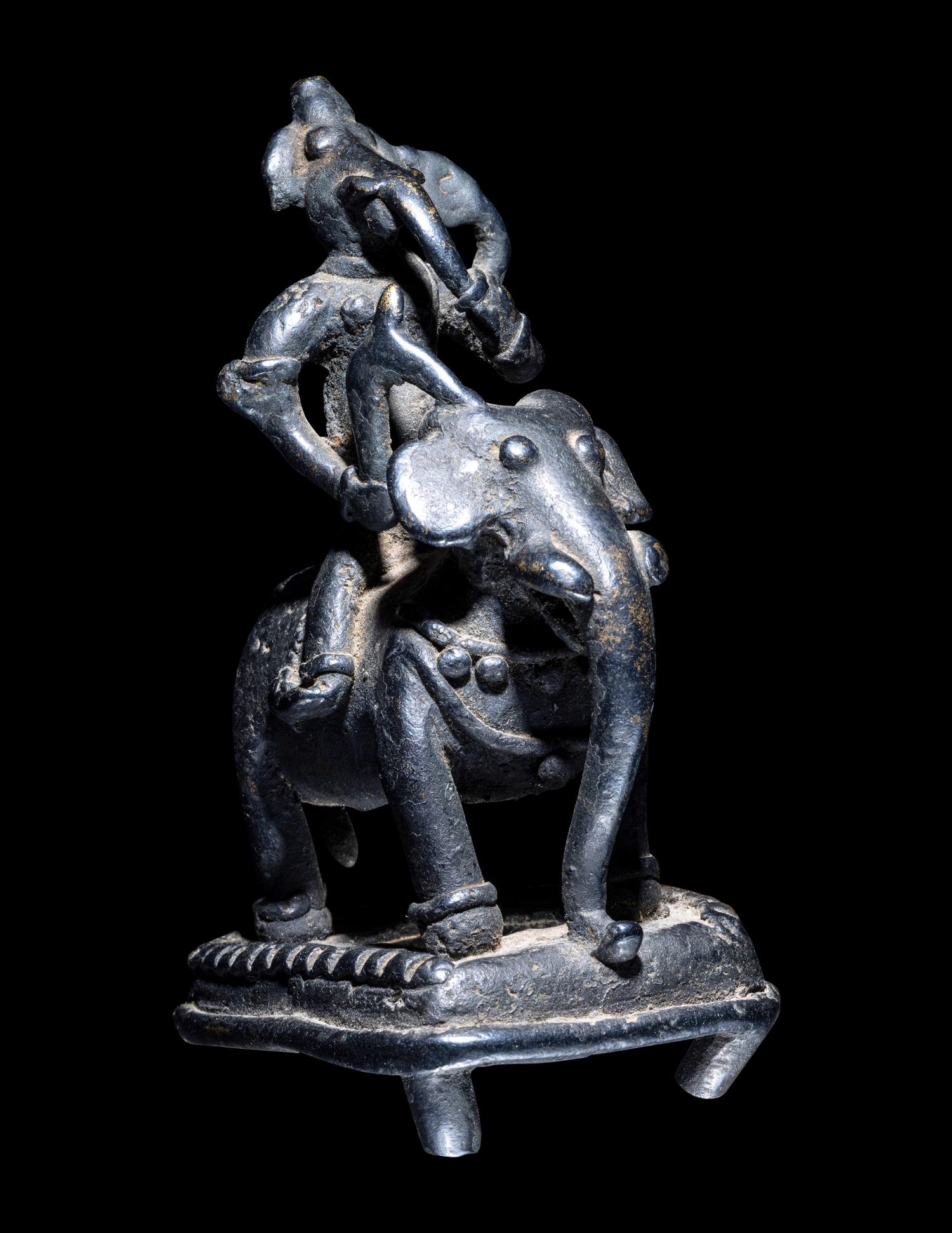 An Indian Bronze Figural Group of Ganesha Riding an Elephant