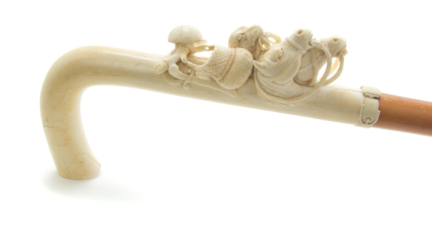 A Continental Relief Carved Ivory Cane, Height of handle 7 1/4 x length overall 34 1/8 inches.