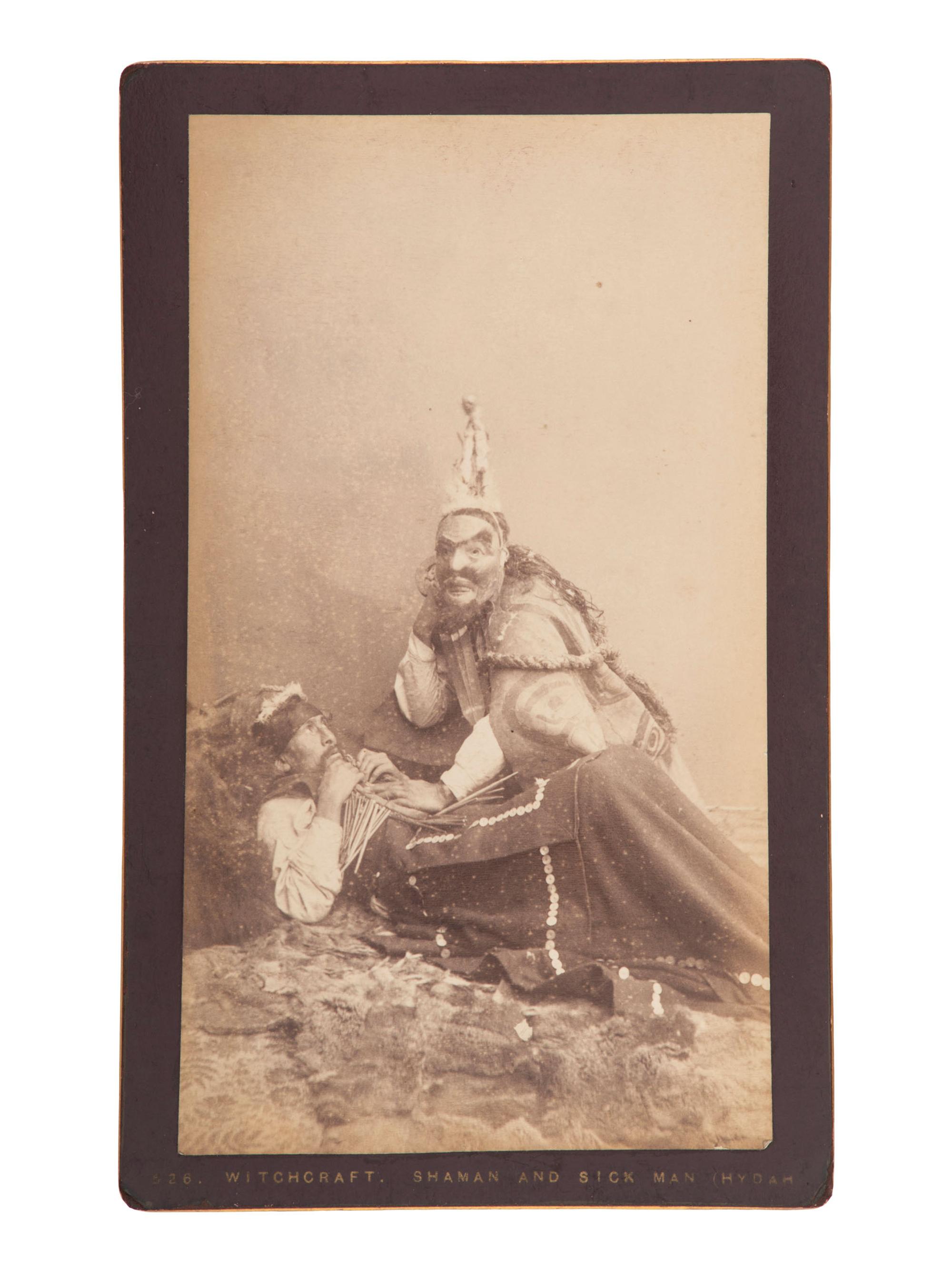 [NATIVE AMERICANS]. DE GROFF, Edward, photographer. Boudoir card featuring a Haida shaman and sick man. Sitka, AK: ca 1890.