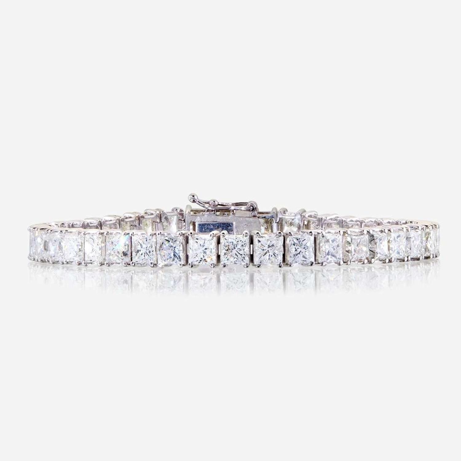 A diamond and fourteen karat white gold line bracelet