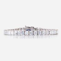A diamond and fourteen karat white gold line bracelet