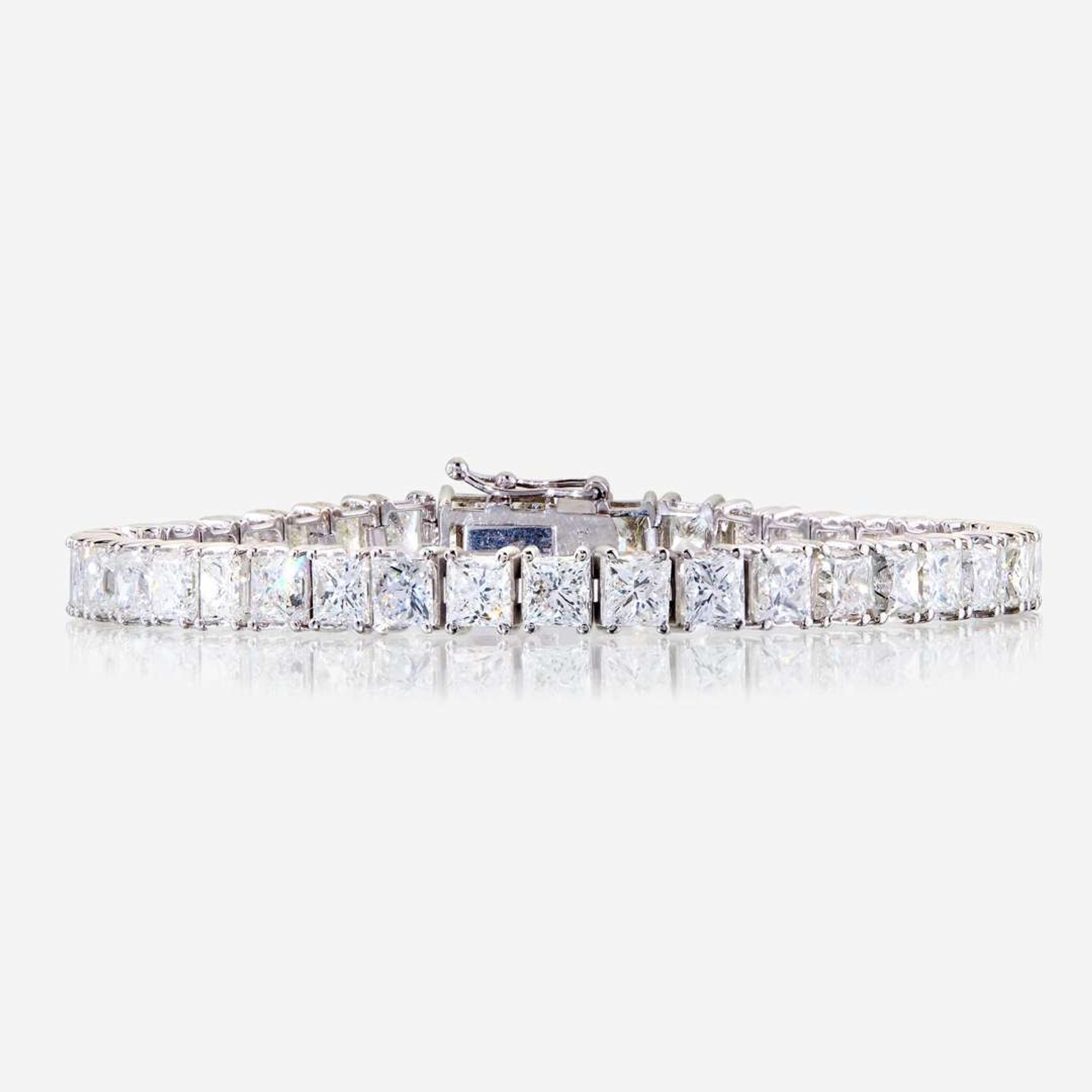 A diamond and fourteen karat white gold line bracelet
