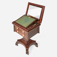 A Classical carved mahogany work table together with Regency mahogany tea caddy The table probably Baltimore, MD, circa 1820-1830