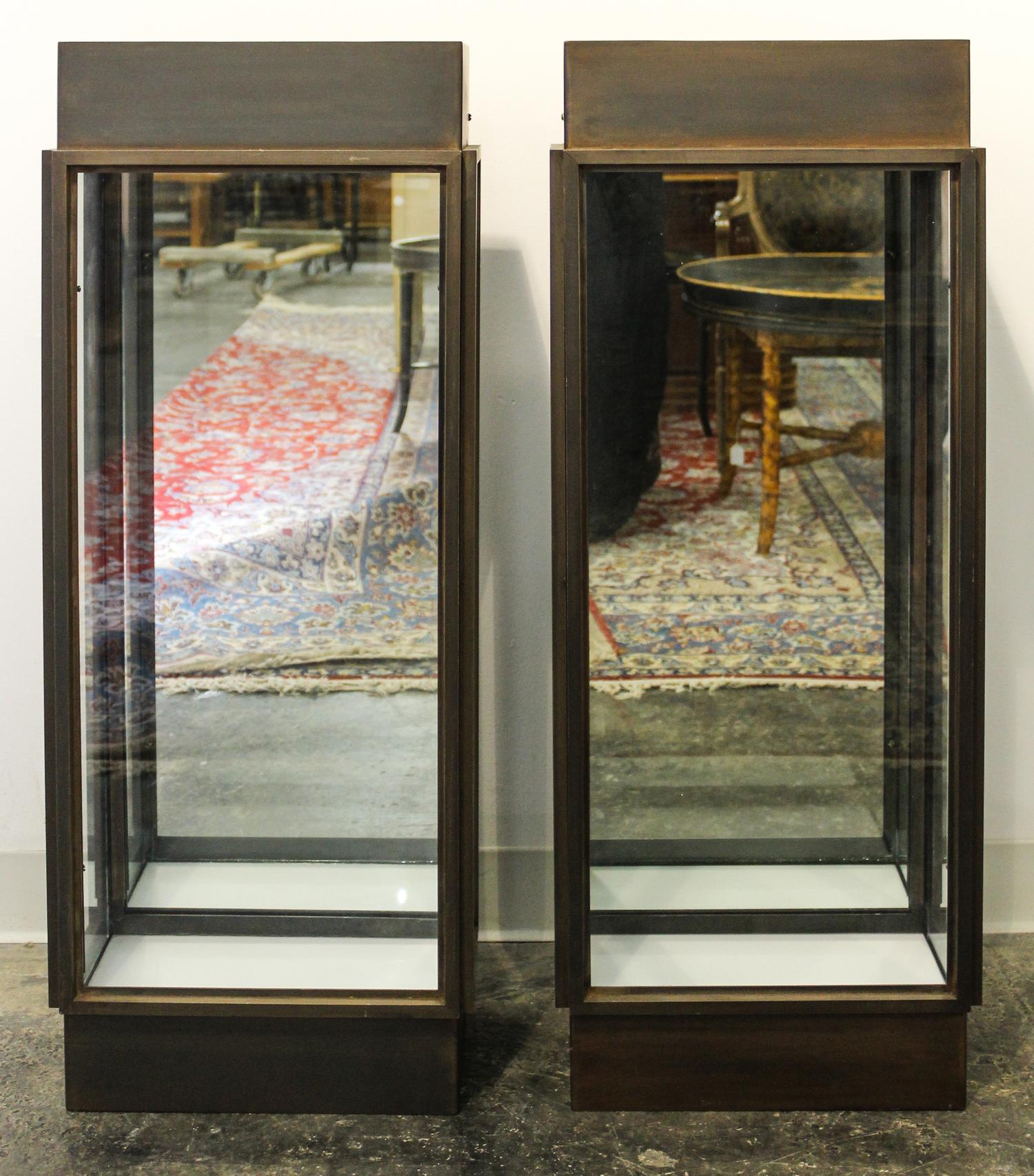 A Pair of Metal and Glass Lighted Pedestals Height 38 x width 15 x depth 8 1/2 inches.