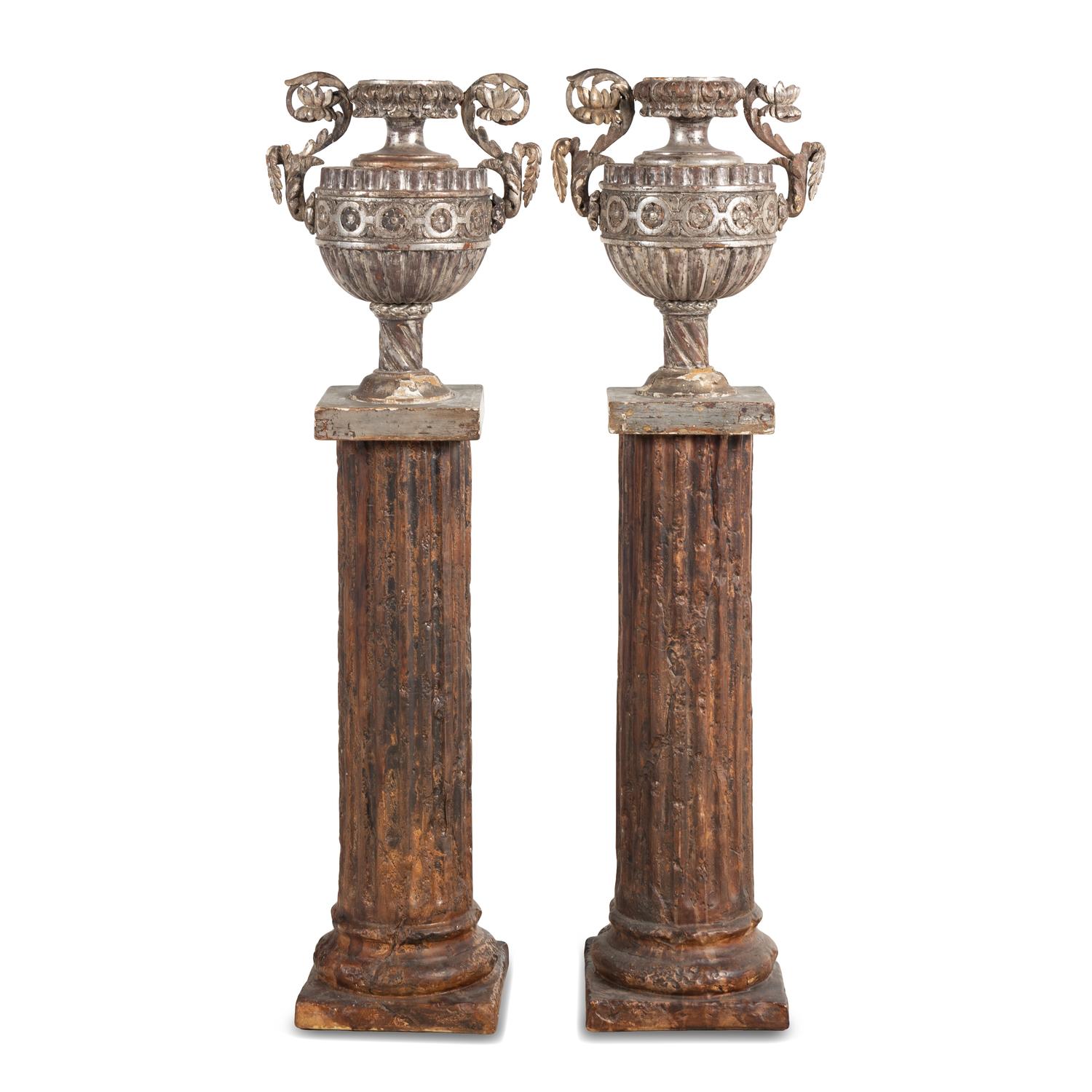 A Pair of Silvered Wood Urn-Form Finials on Painted Columnar Pedestals