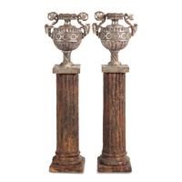 A Pair of Silvered Wood Urn-Form Finials on Painted Columnar Pedestals